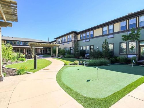 Private residents-only courtyard with putting green and covered pergola at Spring Gardens Holladay senior living in Holladay, Utah.